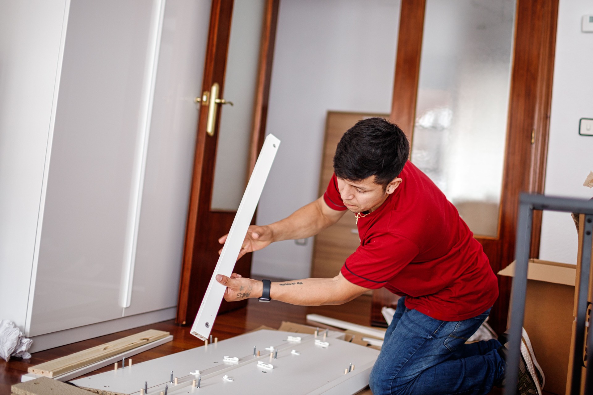 Young man assembling furniture